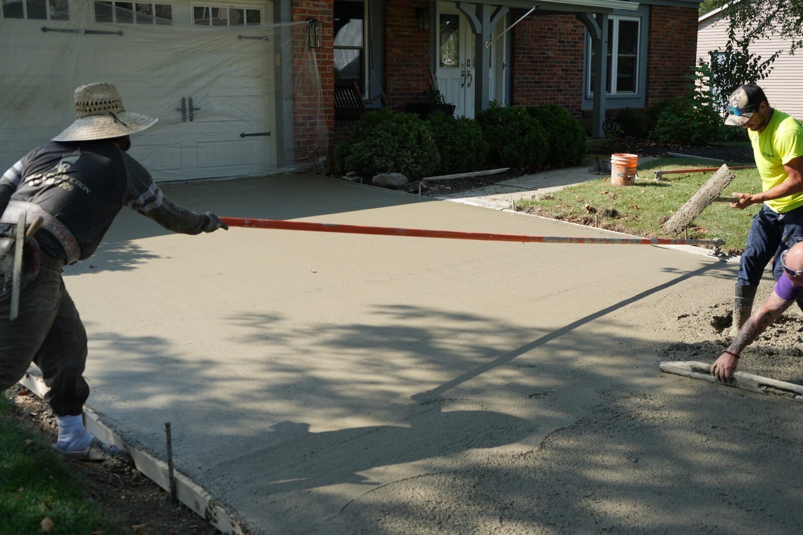 Fresh concrete being poured and leveled